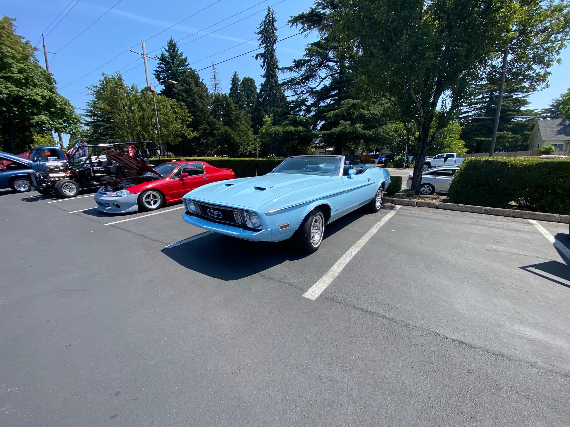 Blue classic convertible parked at Hot Rods and Dad Bods.