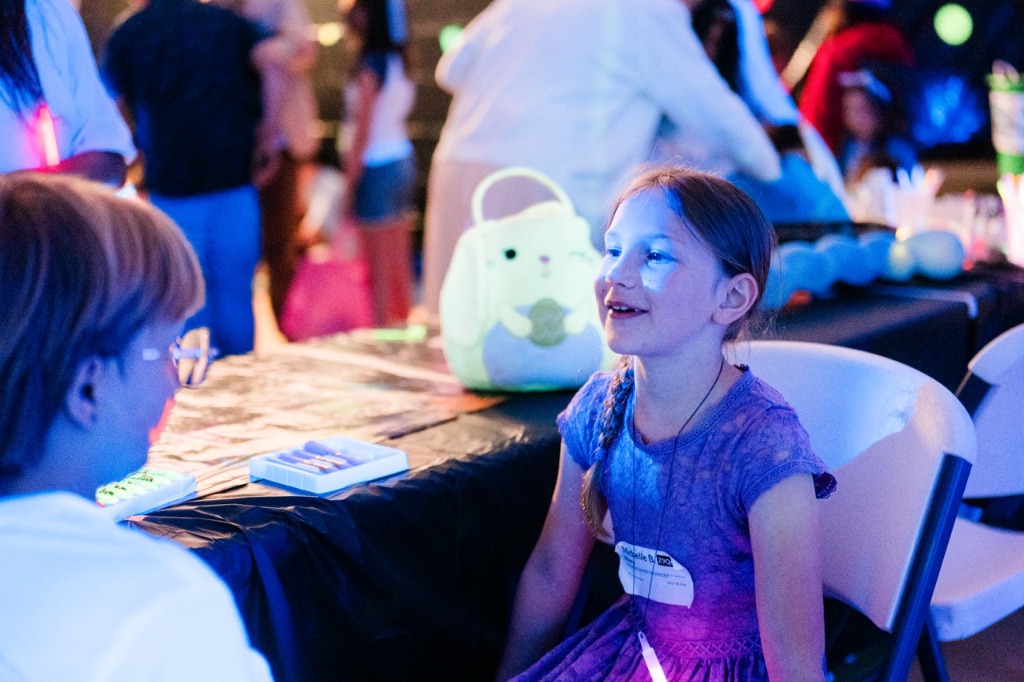 A child enjoying an activity at the Crossroads Neon Egg Hunt
